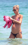 MICHELLE HUNZIKER ENJOYS A DAY AT THE BEACH IN IBIZA