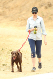 Anne Hathaway cleans up after her pooch