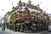 The Churchill Arms pub and its famous hanging baskets of flowers, Kensington Church St, London, Britain - 26 Jul 2013