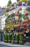 The Churchill Arms pub and its famous hanging baskets of flowers, Kensington Church St, London, Britain - 26 Jul 2013