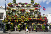 The Churchill Arms pub and its famous hanging baskets of flowers, Kensington Church St, London, Britain - 26 Jul 2013