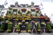 The Churchill Arms pub and its famous hanging baskets of flowers, Kensington Church St, London, Britain - 26 Jul 2013