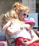 EXCLUSIVE Isla Fisher carries sleeping daughter's slipper in her mouth