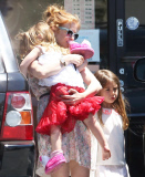 EXCLUSIVE Isla Fisher carries sleeping daughter's slipper in her mouth
