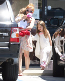 EXCLUSIVE Isla Fisher carries sleeping daughter's slipper in her mouth