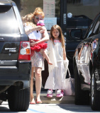 EXCLUSIVE Isla Fisher carries sleeping daughter's slipper in her mouth