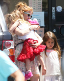 EXCLUSIVE Isla Fisher carries sleeping daughter's slipper in her mouth