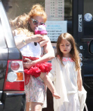 EXCLUSIVE Isla Fisher carries sleeping daughter's slipper in her mouth