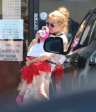 EXCLUSIVE Isla Fisher carries sleeping daughter's slipper in her mouth