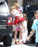 EXCLUSIVE Isla Fisher carries sleeping daughter's slipper in her mouth