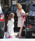 EXCLUSIVE Isla Fisher carries sleeping daughter's slipper in her mouth