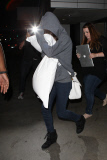 Selena Gomez covers up from cameras at LAX