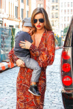 Mirand Kerr carries a sleepy Flynn