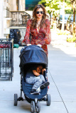 Mirand Kerr carries a sleepy Flynn
