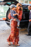 Mirand Kerr carries a sleepy Flynn
