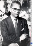 Karl Lagerfeld 1987 Chanel Dress Designer Karl Lagerfeld With Some Of His Creations Exhibited At Sotheby's. Also Portraits In Front Of A Montage....fashion Designer