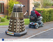 Man transports lifesize Dr Who Dalek prop by towing it behind a mobility scooter, Hampshire, Britain - 21 Sep 2013
