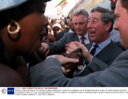 PRINCE CHARLES VISITS THE TRENCHTOWN COMMUNITY CENTRE IN JAMAICA, HE IS PRESENTED WITH A SET OF FAKE DREADLOCKS BY RITA MARLEY, WIFE OF THE LATE BOB MARLEY. UNFORTUNATELY HE WEARS THEM THE WRONG WAY ROUND