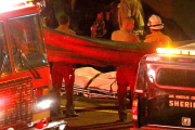 Coroners examine Paul Walker at the site of his Tragic Death