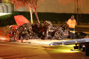 Coroners examine Paul Walker at the site of his Tragic Death