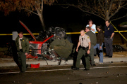Coroners examine Paul Walker at the site of his Tragic Death