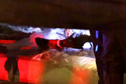 Coroners examine Paul Walker at the site of his Tragic Death