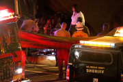 Coroners examine Paul Walker at the site of his Tragic Death