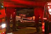 Coroners examine Paul Walker at the site of his Tragic Death