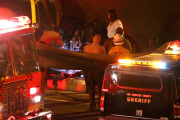 Coroners examine Paul Walker at the site of his Tragic Death