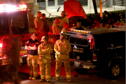 Coroners examine Paul Walker at the site of his Tragic Death