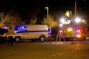 Coroners examine Paul Walker at the site of his Tragic Death