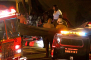 Coroners examine Paul Walker at the site of his Tragic Death