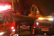 Coroners examine Paul Walker at the site of his Tragic Death