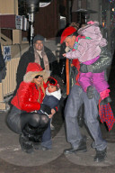 Mariah Carey and Nick Cannon keep a tight hold of the twins as they take a snowy stroll