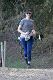 Anne Hathaway runs in the same paparazzo she left a doggie treat for on Thursday