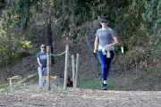 Anne Hathaway runs in the same paparazzo she left a doggie treat for on Thursday