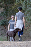Anne Hathaway runs in the same paparazzo she left a doggie treat for on Thursday