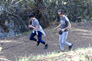 Anne Hathaway runs in the same paparazzo she left a doggie treat for on Thursday