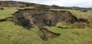 A field has disappeared into a giant sink hole at Foolow in The Derbyshire Peak District.  Locals claim the huge hole, measuring more than 160 ft across and 130 ft deep, which began collapsing yesterday and is still growing, was caused when part