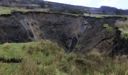A field has disappeared into a giant sink hole at Foolow in The Derbyshire Peak District.  Locals claim the huge hole, measuring more than 160 ft across and 130 ft deep, which began collapsing yesterday and is still growing, was caused when part
