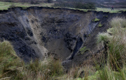 A field has disappeared into a giant sink hole at Foolow in The Derbyshire Peak District.  Locals claim the huge hole, measuring more than 160 ft across and 130 ft deep, which began collapsing yesterday and is still growing, was caused when part