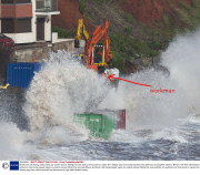 Workman risk being swept away by violent waves hitting the sea wall as they work to repair the railway way line and breached sea defences at Dawlish, Devon, Britain - 08 Feb 2014