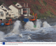 Workman risk being swept away by violent waves hitting the sea wall as they work to repair the railway way line and breached sea defences at Dawlish, Devon, Britain - 08 Feb 2014