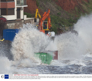Workman risk being swept away by violent waves hitting the sea wall as they work to repair the railway way line and breached sea defences at Dawlish, Devon, Britain - 08 Feb 2014