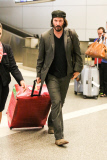 Keanu Reeves is a happy jetsetter at LAX