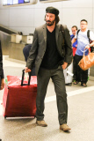 Keanu Reeves is a happy jetsetter at LAX