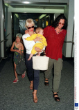 PAULA YATES AND MICHAEL HUTCHENCE AT LONDON HEATHROW AIRPORT, BRITAIN - 1997