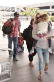 Lance Armstrong carts his son Max on a suitcase before a flight at LAX