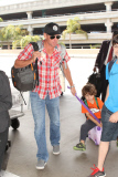 Lance Armstrong carts his son Max on a suitcase before a flight at LAX