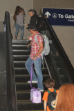 Lance Armstrong carts his son Max on a suitcase before a flight at LAX